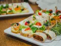 Nietypowe przekąski na imprezę: kanapeczki z łososiem, serkiem, pomidorkami, zielone roladki i tortille.