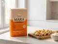 Idealna mąka pszenna typ 500 "Luksusowa" do pierogów. Na desce gotowe pierogi z cebulką i miseczka mąki.